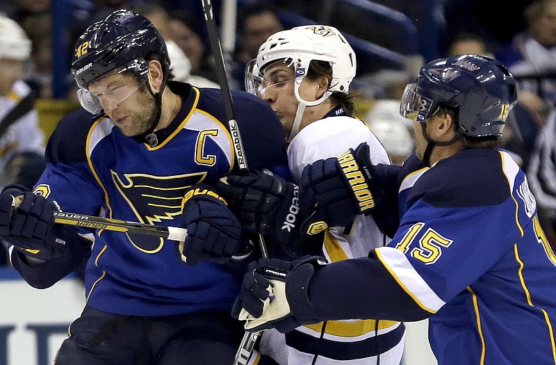 Gabriel Bourque of the Predators is caught between Blues' teammates David Backes and Jamie Langenbrunner during Tuesday night's game in St. Louis.