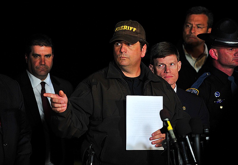 Dale County Sheriff Wally Olsen answers questions from the media about the close of the hostage crisis during a news conference late Monday in Midland City, Ala. 