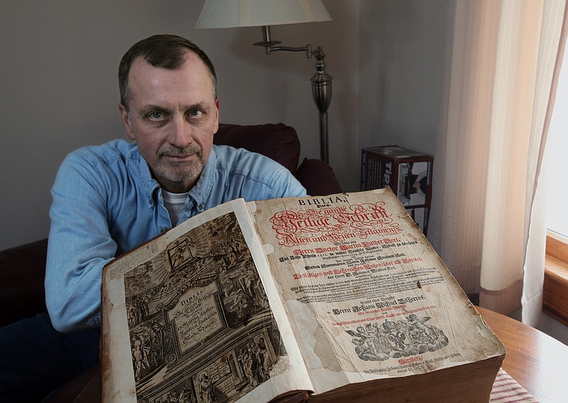Tim Shier holds up his family Bible dating from the 1700's in his home in Marysville, Ohio. The Lutheran Bible, written in German Gothic script and containing the handwritten dates of births, deaths and marriages for seven generations of Tim Shier's family, went missing in the burglary in Marysville, near Columbus, in December 2011. 