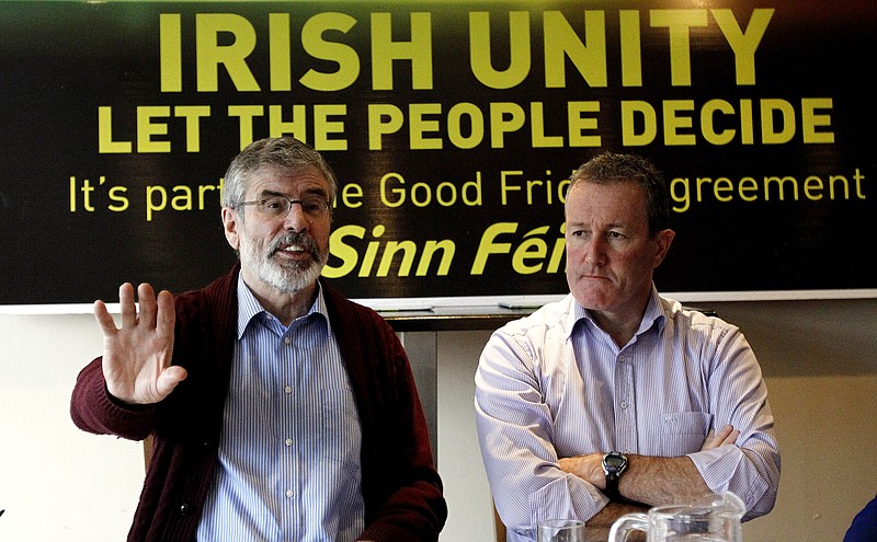 Sinn Fein President Gerry Adams, left, and party colleague Conor Murphy speak to the media and party members Friday in Dundalk, Ireland. The leader of the Irish nationalist Sinn Fein party has appealed to IRA splinter groups to stop their violence and to support his campaign for a vote in Northern Ireland on uniting the island.