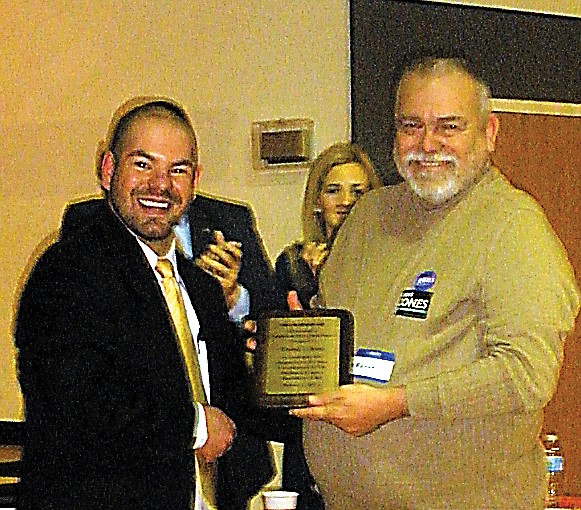 Moniteau County Republican Club President Bryan Wolford presents Darrel L. King with the Lincoln Day Republican of the Year award for 2012. King has served as the county assessor for a number of years and will retire in a few months.