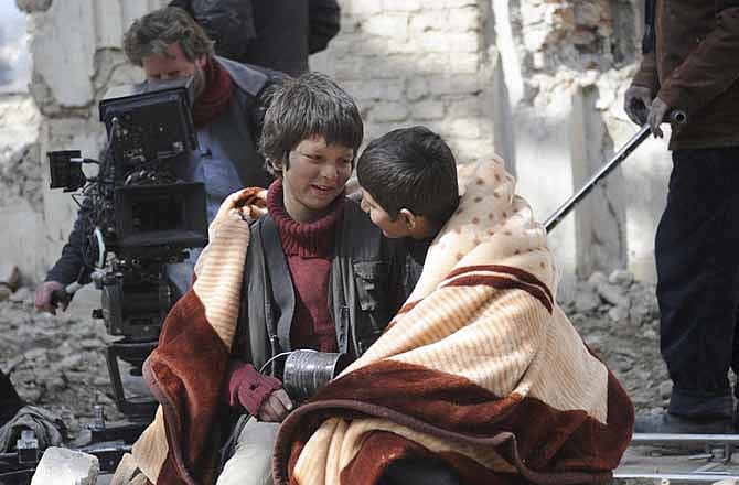 An undated production still photograph from the Oscar-nominated film, "Buzkashi Boys," which was filmed in Kabul, Afghanistan, shows actors Jawanmard Paiz, center, Fawad Mohammadi, right, and director Sam French at work on the set of the film. The actors were plucked from the dingy streets of the Afghan capital to be the main stars of "Buzkashi Boys," a coming-of-age movie filmed entirely in a war zone and nominated in the Best Live Action Short Film category.