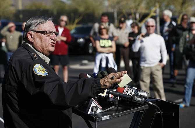 As school parents and volunteer posse members listen, Maricopa County Sheriff Joe Arpaio speaks with the media talking about the Sheriff's new program providing security around schools in his jurisdiction, at Anthem Elementary School Wednesday, Jan. 9, 2013, Phoenix. 