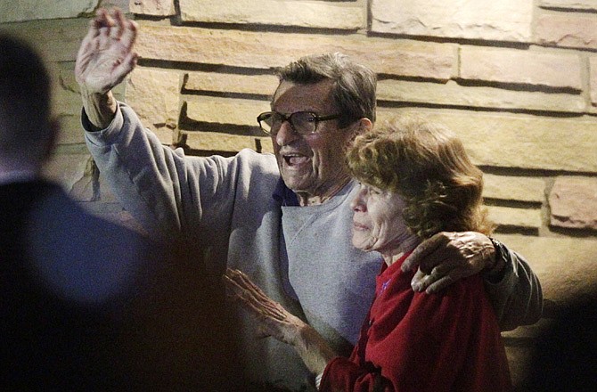 In this Nov. 9, 2011, file photo, former Penn State coach Joe Paterno and his wife, Sue Paterno, stand on their porch to thank supporters gathered outside their home in State College, Pa.