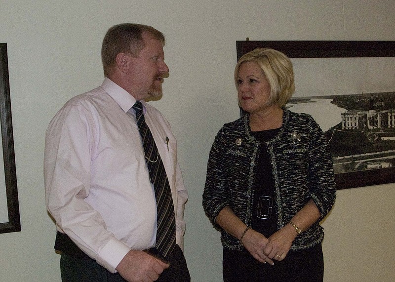 Rep. Charlie Davis, R-Webb City, left, discusses proposed legislation affecting Missouri veterans with Rep. Sheila Solon, R-Blue Springs at the state Capitol. 