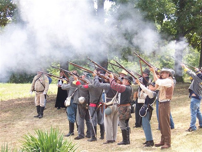 Reenactors fire their guns during the 150th anniversary of the Battle of Moore's Mill July 28, 2012 at the site of the battle in Calwood. In March, an archeological survey made possible through an American Battlefield Protection Program and organized by the Missouri Civil War Heritage Foundation and Kingdom of Callaway Civil War Heritige will search for artifacts of the battle in the largest historical research effort of Callaway's most significant Civil War skirmish.