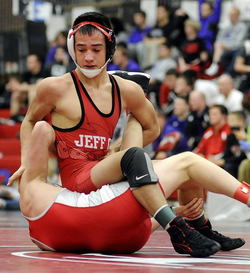 Corbin Howard of Jefferson City works against Naseeph Al-Roubaie of Nixa in the 113-pound third-place match last Saturday at Fleming Fieldhouse. Howard is one of four state tournament qualifiers for the Jays.