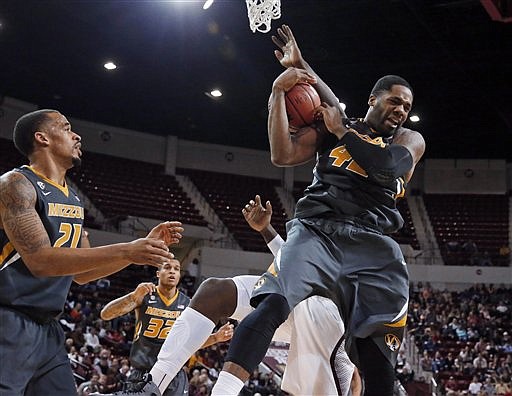 Alex Oriakhi of Missouri hauls in a rebound in front of Mississippi State's Gavin Ware during the first half of Wednesday night's game in Starkville, Miss.