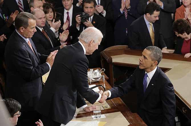 President Barack Obama shakes hands with Vice President Joe Biden after the president gave his State of the Union address during a joint session of Congress on Capitol Hill in Washington, Tuesday Feb. 12, 2013. House Speaker John Boehner of Ohio is at left.