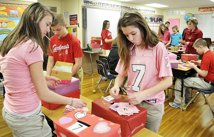 Students from Immaculate Conception School are on a mission to raise as much money as they can to help out Oscar's Classic Diner employees. Here, Sidney Schroeder, left, Jeremiah Heckman, middle, and Abby Dowden count Valentine cards sold at school over the past couple of weeks. Money raised by sales of the cards will go to employees of Oscar's.