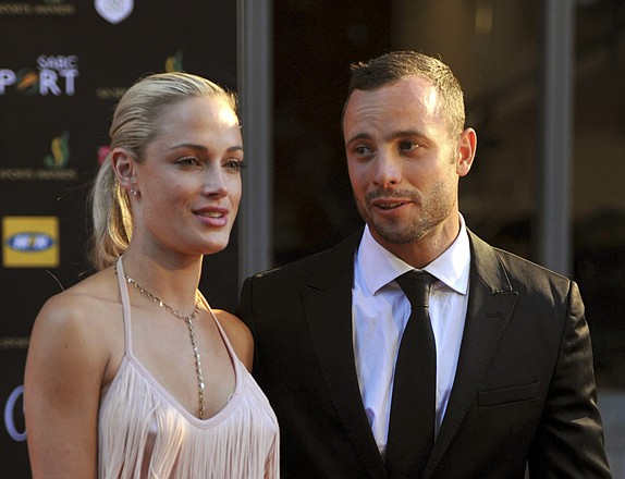 South African Olympic athlete Oscar Pistorius and his girlfriend, Reeva Steenkamp, attend an awards ceremony Nov. 4 in Johannesburg, South Africa. Pistorius was charged Thursday with Steenkamp's murder after she was found shot to death in his house.