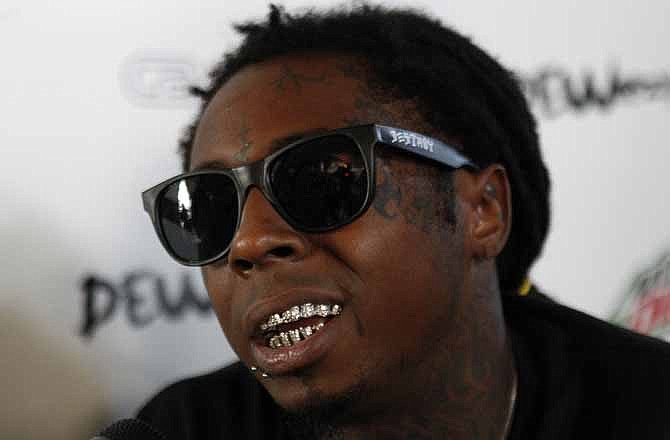 In this Sept. 26, 2012 file photo, recording artist Lil Wayne speaks during an interview with The Associated Press in New Orleans.