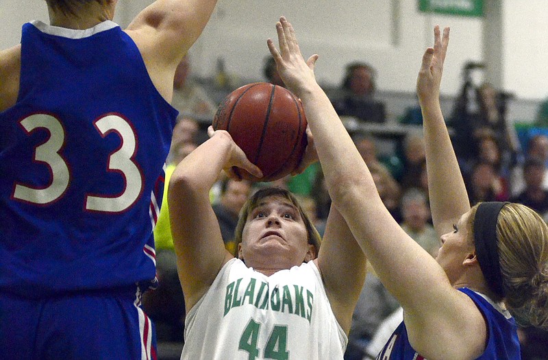 Amy Dorge of Blair Oaks tries to put up a shot between the defensive efforts of California teammates Sydney Deeken (33) and Kelsey Roush during Thursday night's game in Wardsville.
