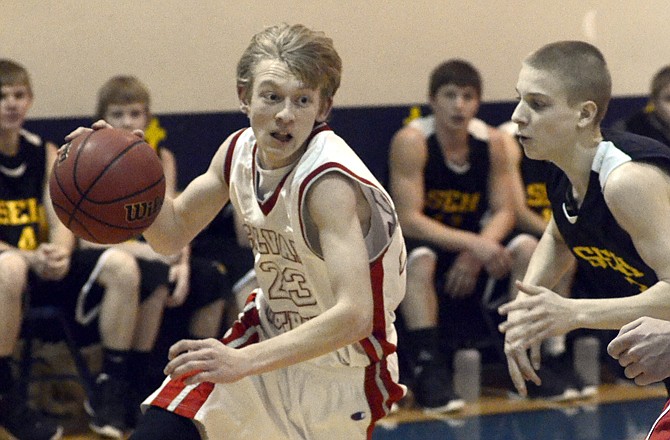 Calvary Lutheran's Beau Monson drives the ball to the basket past Braydon Holtmeyer of St. Elizabeth during Friday night's game at Trinity Lutheran.