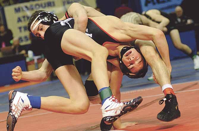 Jefferson City's Logan Moriarity battles to avoid being taken to the mat by Park Hill's William Erneste in the Class 4 120-pound third-place match during action at the state wrestling tournament Saturday at Mizzou Arena.