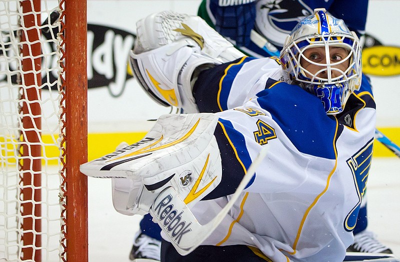 Blues goalie Jake Allen watches the puck (upper left) go into the net during Sunday night's game against the Canucks in Vancouver, British Columbia.