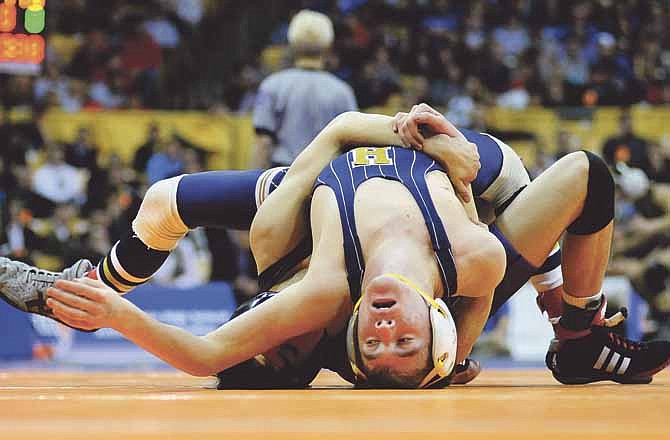 Dylan Linsenbardt of Helias (front) takes on Kearney's Jaret Singh in the Class 3 113-pound title match during the state wrestling tournament Saturday at Mizzou Arena.