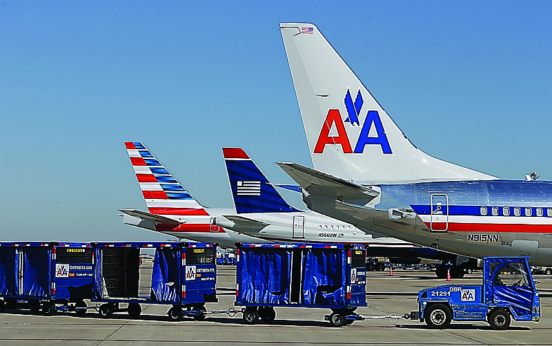 U.S. Airways and American Airlines planes are shown at gates at DFW International Airport in Grapevine, Texas. The two airlines will merge forming the world's largest airlines.  