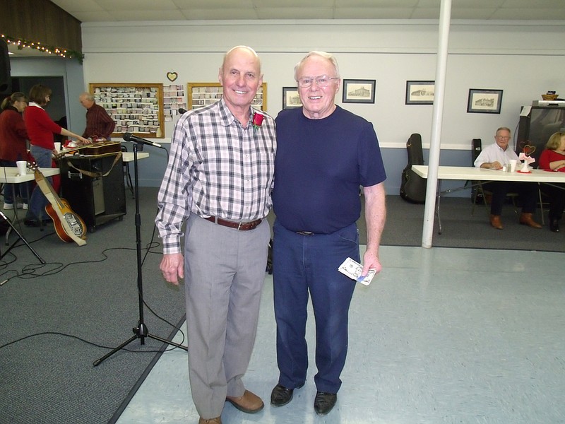 Photo submitted
Cecil Knernschield, Bunceton, at left, received the 50/50 drawing award from Bob Taylor at Saturday's dance.  Knernschield donated the money back to the center.