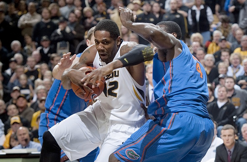 Missouri's Alex Oriakhi fights his way through a pair of Florida defenders on his way to the basket during the first half of Tuesday's game in Columbia.