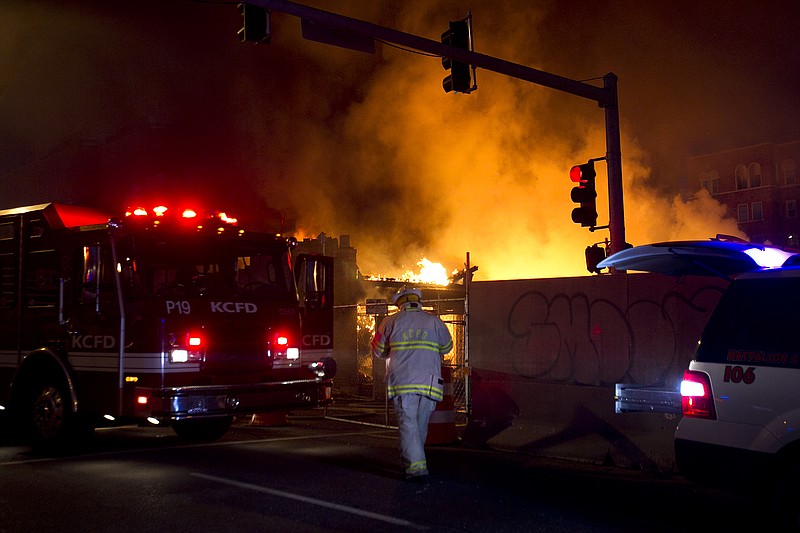 Firefighters work on the scene of a gas explosion and massive fire Tuesday at JJ's restaurant at the Country Club Plaza in Kansas City. Officials believe a utility contractor may have caused the blast, sparking a massive blaze that engulfed an entire block and caused multiple injuries.