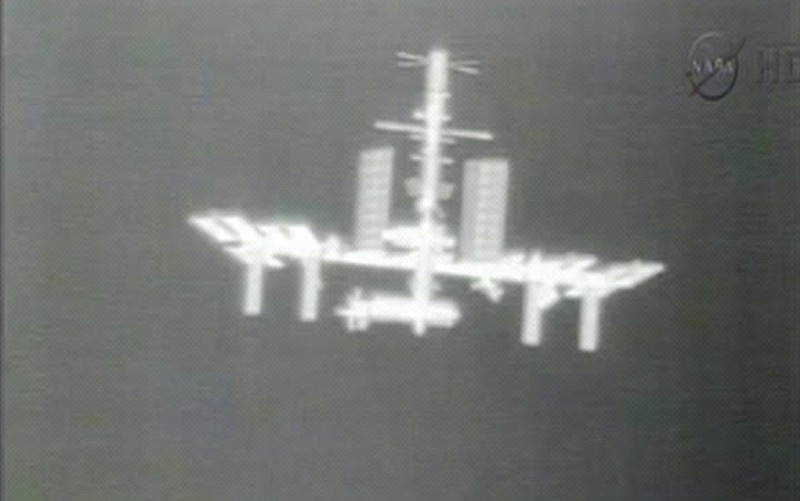 This Thursday, May 24, 2012 image made from video provided by NASA-TV shows the International Space Station taken from the thermal imaging camera aboard the SpaceX Dragon commercial cargo craft as it approaches the station. The International Space Station regained contact with NASA controllers in Houston after nearly three hours of accidental quiet, the space agency says.