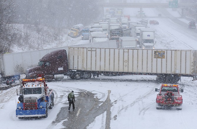 Crews respond to a multi-vehicle accident on Interstate 94 in Benton Township, Mich., after a winter storm dumped several inches of snow in Southwest Michigan. 