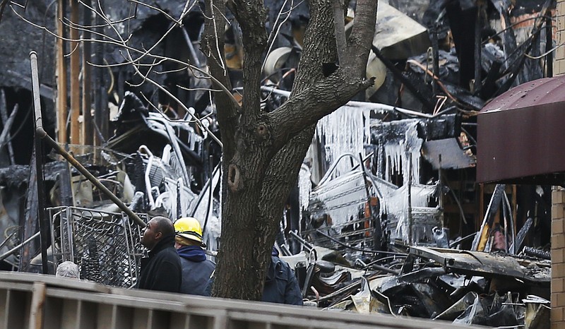 Officials inspect a burned out JJ's Restaurant on Wednesday at the Plaza shopping district of Kansas City, Mo.  Search crews recovered one body Wednesday, and the city's mayor said there was no certainty the rubble wasn't concealing other victims.  A natural gas leak turned into an explosion that leveled the building on Tuesday evening.