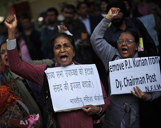 Protesters hold placards near Indian parliament Thursday to protest a new sexual violence law as the parliament convenes in New Delhi, India. Activists say the law is inadequate. 