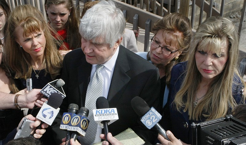 Former Pennsylvania state Sen. Jane Orie, left, her sisters Janine Orie, right, and Pennsylvania Supreme Court Justice Joan Orie Melvin, center right, listen as their brother Jack Orie, center, reads a statement in April 2010 to the press outside a magistrate's office in Pittsburgh. With the conviction of Melvin and Janine Orie on Thursday, and Jane Orie's 2012 conviction, all three sisters were found guilty in campaign related in campaign corruption crimes.