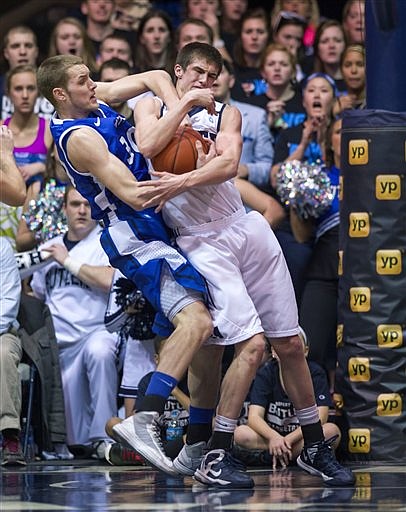 Jake Barnett of Saint Louis (left) battles Andrew Smith of Butler for a rebound Friday night in Indianapolis.