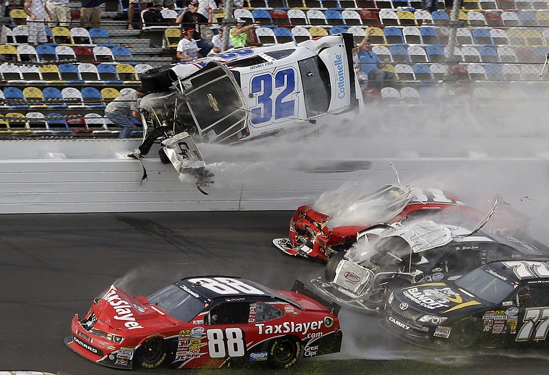 Kyle Larson's car goes airborne and into the catch fence in a multi-car crash during the final lap of the Nationwide race at Daytona International Speedway on Saturday. Fans appeared to be injured during the crash.