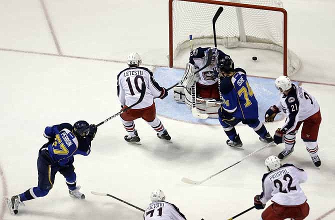 St. Louis Blues' David Perron, bottom left, scores past Columbus Blue Jackets goalie Sergei Bobrovsky, of Russia, during the third period of an NHL hockey game Saturday, Feb. 23, 2013, in St. Louis. The Blues won 2-1.