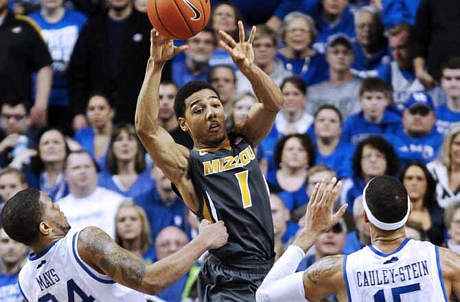 Missouri's Phil Pressey (1) passes between Kentucky's Julius Mays (34) and Willie Cauley-Stein during the second half of an NCAA college basketball game at Rupp Arena in Lexington, Ky., Saturday, Feb. 23, 2013. Kentucky defeated Missouri 90-83 in overtime.