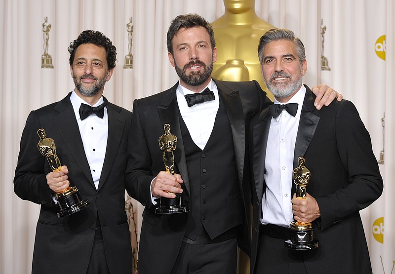 Grant Heslov, from left, Ben Affleck, and George Clooney pose with their award for best picture for "Argo" during the Oscars at the Dolby Theatre on Sunday in Los Angeles.