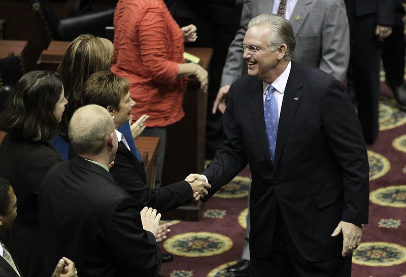 In this Jan. 28 file photo, Missouri Gov. Jay Nixon shakes hands with lawmakers before delivering the annual State of the State address in Jefferson City. When it comes to money in politics, the sky is the limit in Missouri where ethics laws are the weakest in the nation, according to Nixon. Nixon vowed during his address to push a ballot initiative to reinstate campaign contribution limits if lawmakers won't do it themselves this year. 