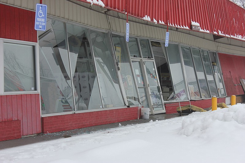 The old Moser's building, 1401 North Bluff St., buckles in on itself after the roof  caved in under snow Tuesday. The building served Fulton as a grocery store for decades, before Moser's Discount Foods moved up the road.