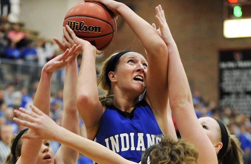 Kennedy Volkart of Russellville fights off a trio of Sturgeon defenders as she puts up a shot during Wednesday night's game at Fleming Fieldhouse.