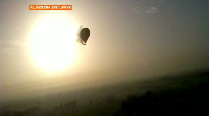 In this image taken from amateur video provided by Al-Jazeera, smoke pours from a hot air balloon on Tuesday over Luxor, Egypt, before bursting and plummeting about 1,000 feet to earth. Nineteen people were killed in what appeared to be the deadliest hot air ballooning accident on record.