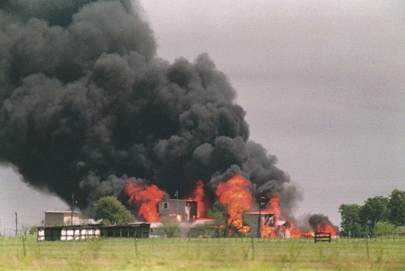 Flames engulf the Branch Davidian compound in Waco, Texas, in this 1993, photo. The 20th anniversary of the botched raid on the Branch Davidians compound passed quietly Thursday as colleagues of the four agents who died gathered in private and local officials made no plans to note the day.