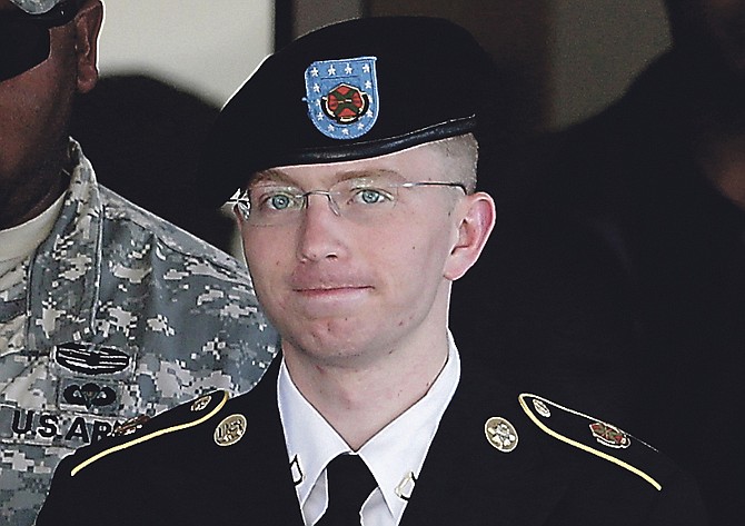 Army Pfc. Bradley Manning, right, is escorted out of a courthouse in Fort Meade, Md.