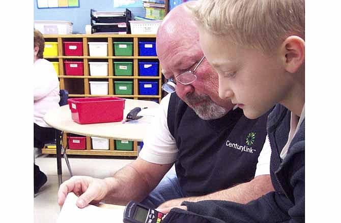 Tanner Pappas shows his grandfather Roy Rutledge how to use the newest piece of technology to be introduced into the Eugene classroom during VIP Day held Friday morning. 