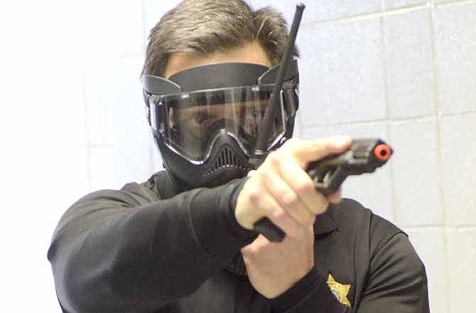 The Cole County Sheriff's Office used Russellville High School to conduct "Active Shooter" training for their officers on Saturday.  The officers used "air-soft" pellet guns which shoot small round rubber bullets that closely simulate the weight and feel of real firearms to make it more realistic.  Here the deputy in training is Ralph Lemongelli as he runs down the hallway in search of the suspect.