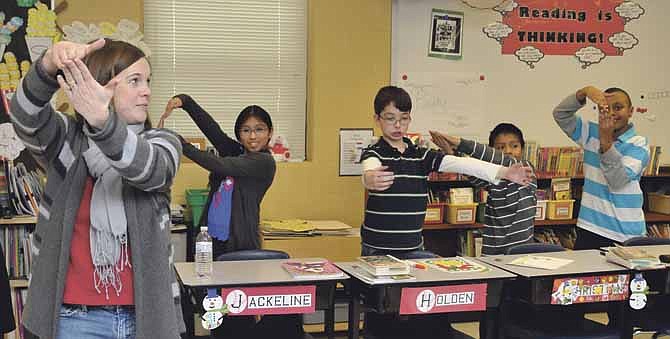 Julie Baker guides her students in her Lawson Elementary School classroom. They are in a science class where they are learning the different parts of plants and their respective roles. Students in the background are Jackeline Bravo, Holden Libbert, Christian Vertiz-Cruz and Thomas Kesete.