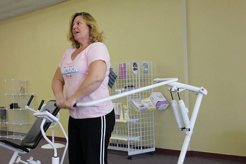 Carolyn Bernicky goes through the workout stations at the Fulton Curves during the gym's closed hours Monday. The gym's new owner, Bernicky said she plans to be visible and work out alongside her customers as she gets to know them.