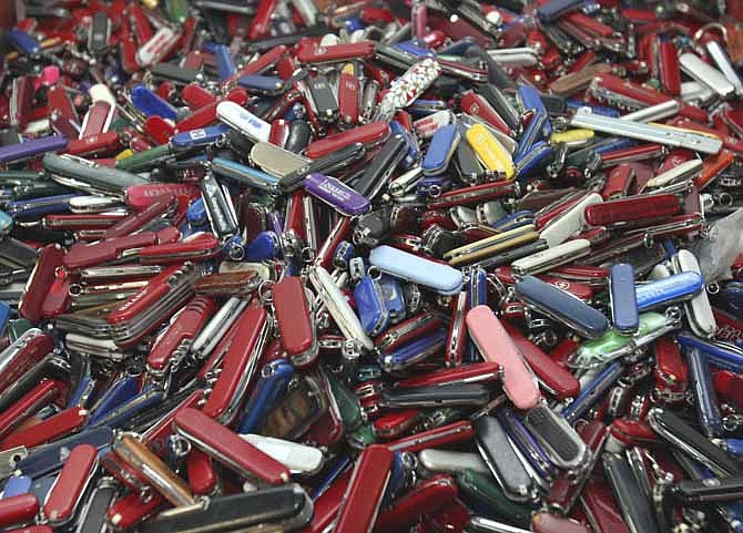 Knives of all sizes and types are piled in a box at the State of Georgia Surplus Property Division store in Tucker, Ga., and are just a few of the hundreds of items discarded at the security checkpoints of Hartsfield-Jackson Atlanta International Airport that will be for sale at the store. Airline passengers will be able to carry small knives, souvenir baseball bats, golf clubs and other sports equipment onto planes beginning in April under a policy change announced Tuesday by the head of the Transportation Security Administration administrator John Pistole.