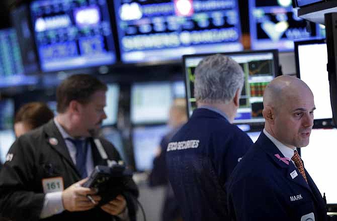 Traders work on the floor at the New York Stock Exchange in New York on Feb. 27. Stocks surged for a second day, putting the Dow on track for its highest close of the year.