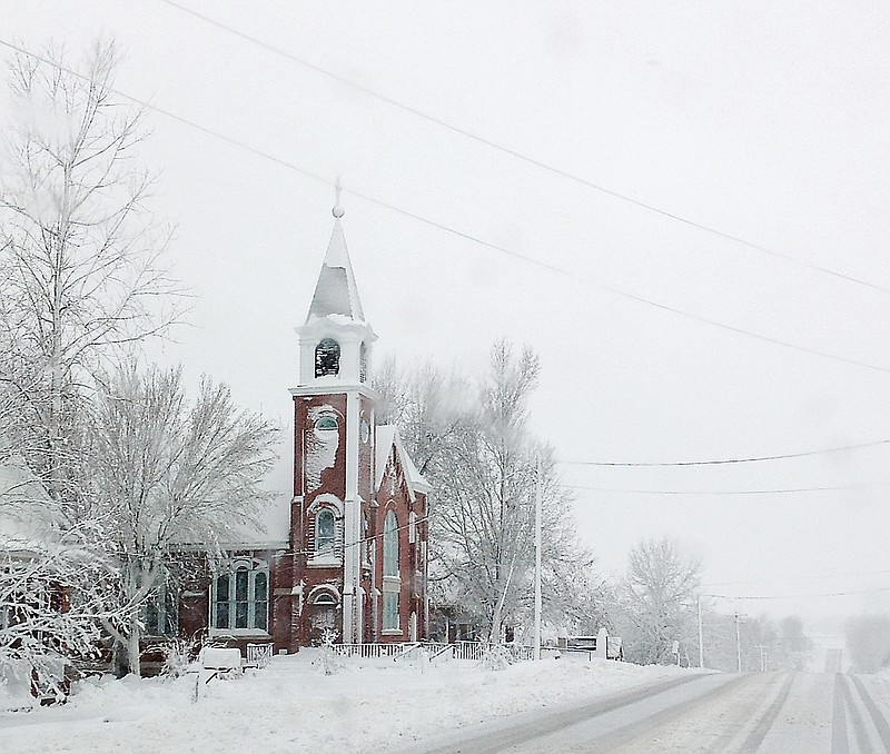 This Tuesday, Feb. 26, 2013 photo shows snow covering Trinity Lutheran Church, located at 13007 Route C in Russellville, Mo.