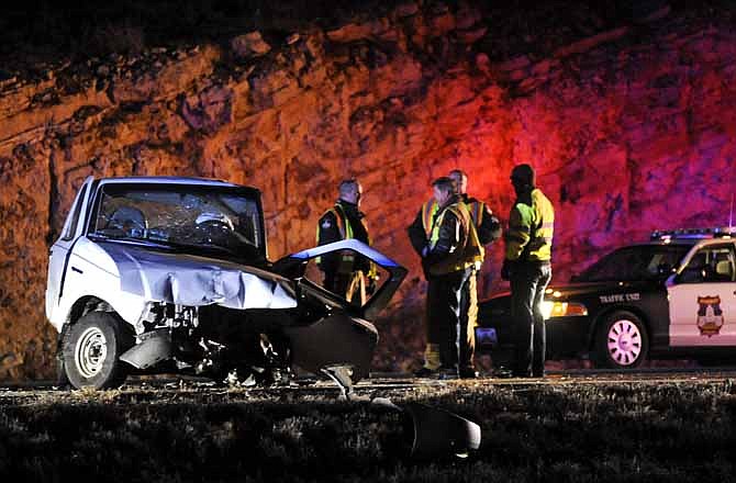 Jefferson City Police officers work the scene of a fatal crash on westbound U.S. 54 at the Missouri 179 overpass late Wednesday night. 