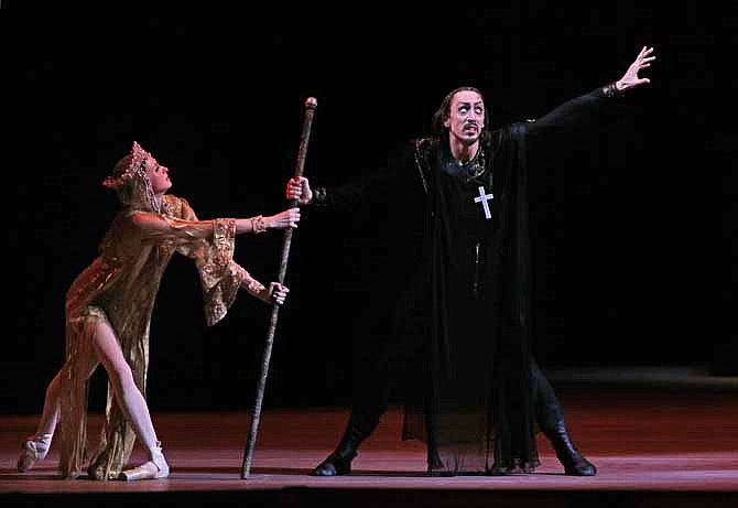 In this November 2012 file photo, Russian dancer Pavel Dmitrichenko, right, as Ivan the Terrible, and ballerina Anna Nikulina as Anastasia, perform at a dress rehearsal of Ivan the Terrible in the Bolshoi Theater in Moscow, Russia. The Russian Interior Ministry says police are searching the home of Pavel Dmitrichenko in connection with the acid attack on the company's artistic director, and have detained another man on suspicion of carrying out the attack.